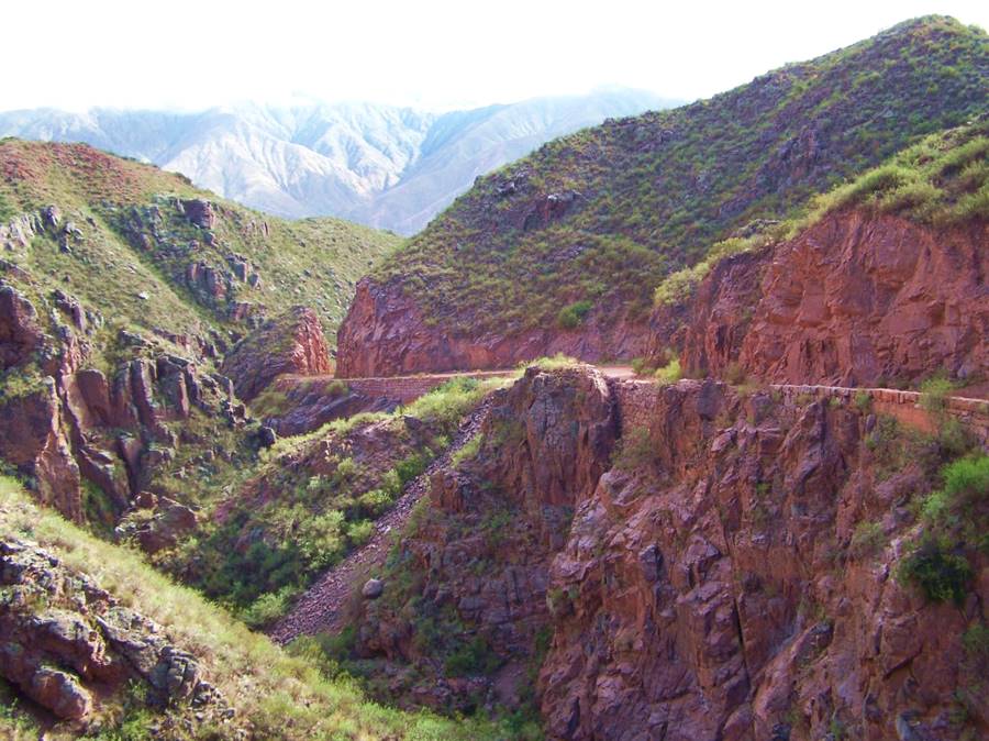 view of the old dirt highway and the red rock cliffs at Cuesta de Miranda