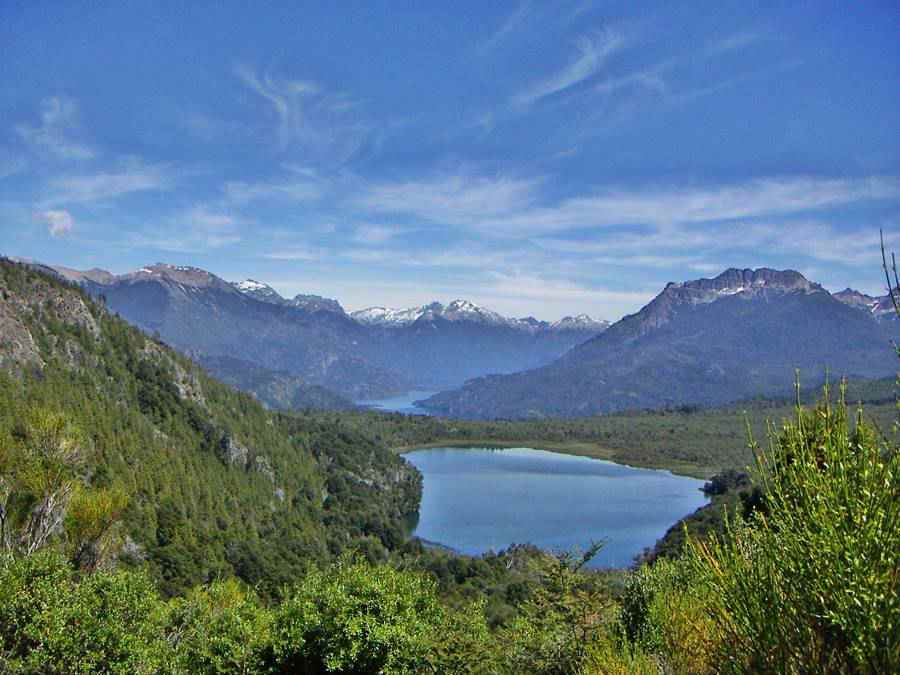 Blue lakes Hualahue and Steffen in a deep forested valley surrounded 
 by snow capped peaks in Nacional Nahuel Huapi national park, Patagonia