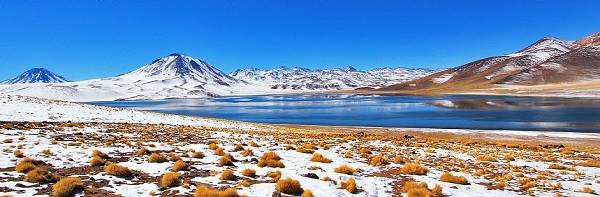 View of lake and snow-capped volcanoes in Atacama, Chile