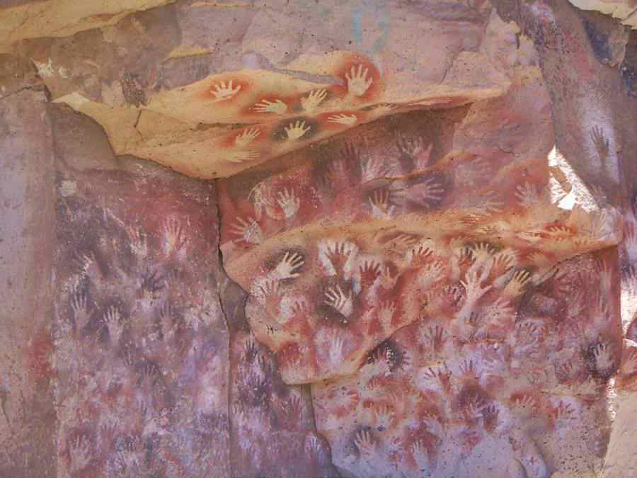 Hands painted on the cliffs, ancient native rock art in Patagonia